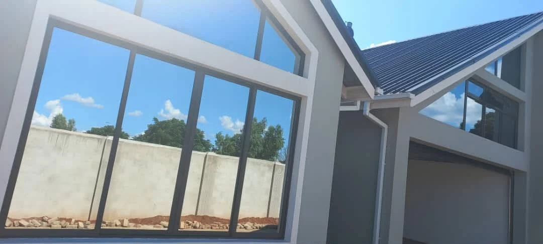 Glazed building windows with reflective film