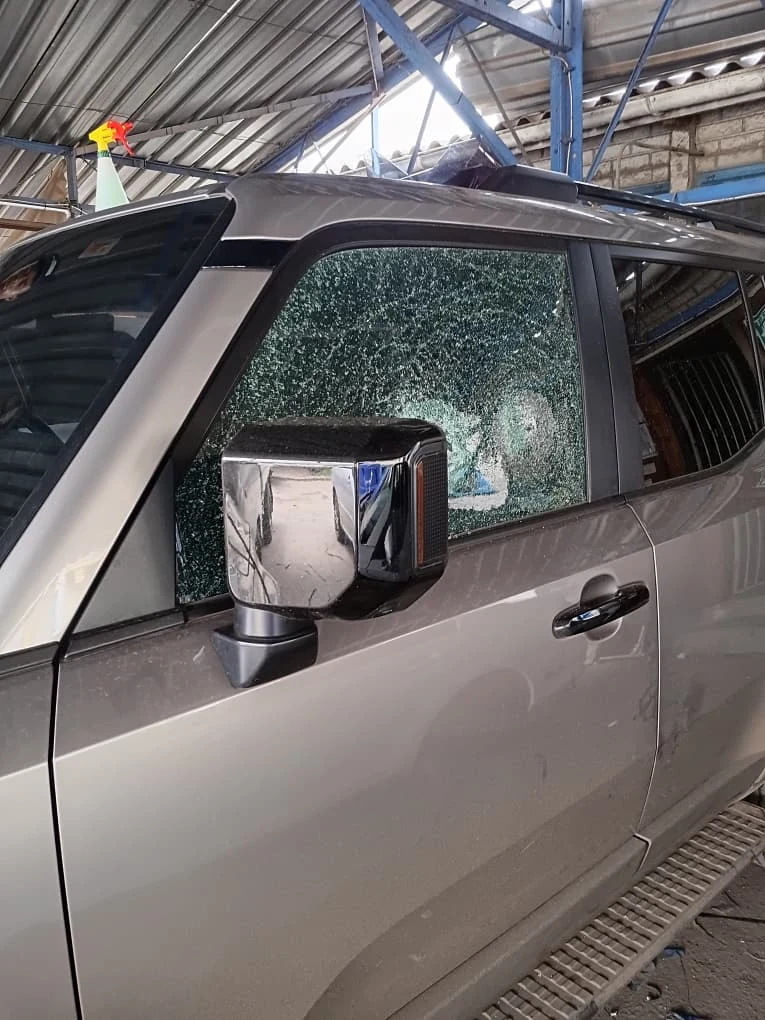 Shattered vehicle door glass awaiting replacement